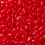 A vibrant pile of red cherry-flavoured jelly beans, gluten-free, halal-friendly, and vegetarian