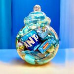 A 3.2L Blue Sweet Jar filled with assorted blue sweets and a can of Fanta USA